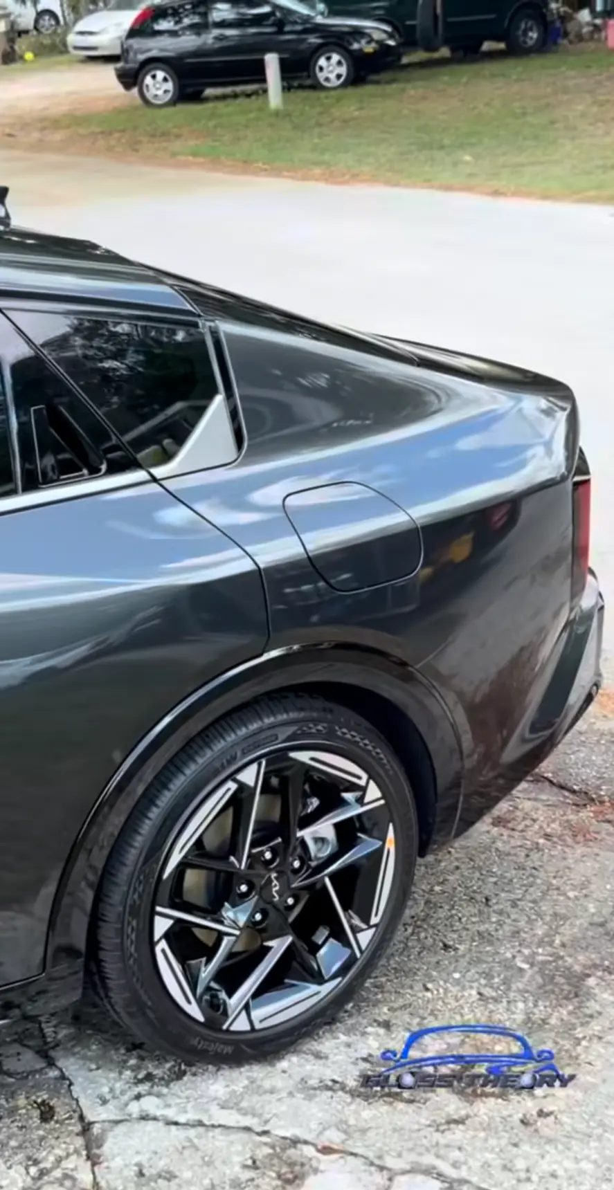 Dark gray sedan with a clean, glossy side profile
